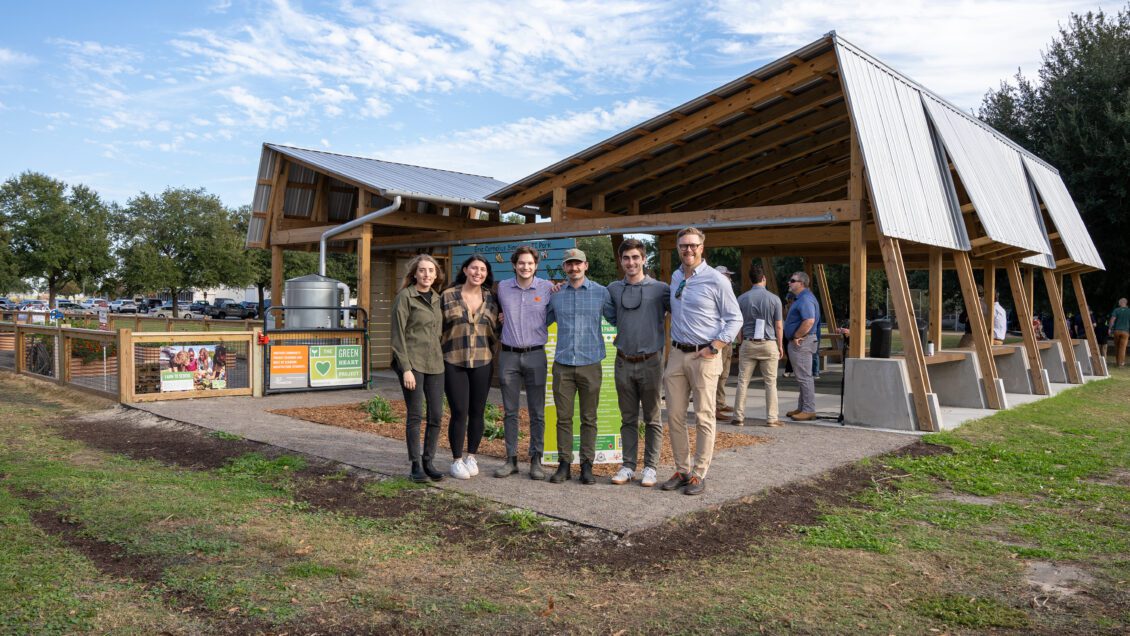 School of Architecture alumni standing in front of a recent A+cB project that was opened to the public.