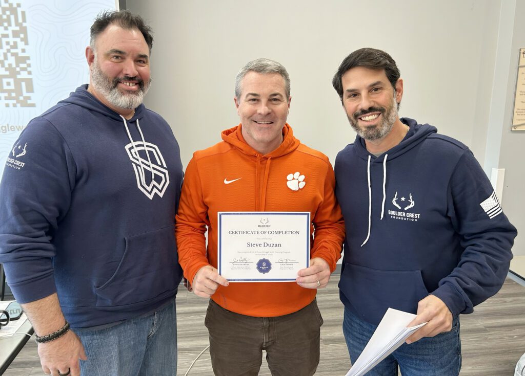 Steve Duzan, middle, receives a certificate of completion for undergoing Struggle Well training Jan. 13-14