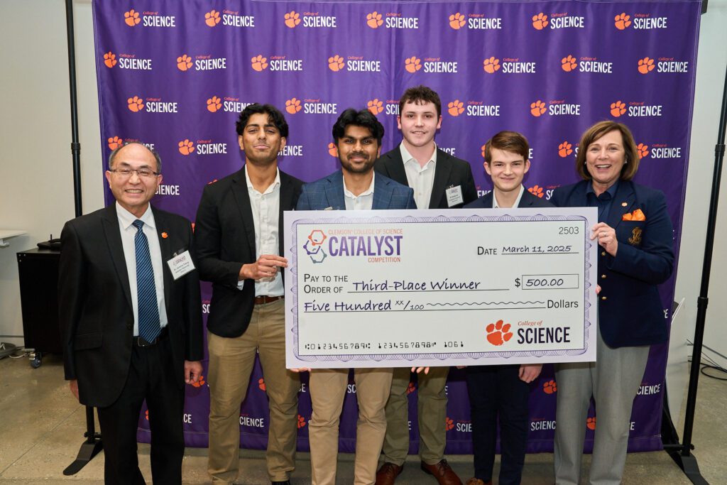 Six people standing with a big check after the Clemson College of Science Catalyst Competition on March 11.