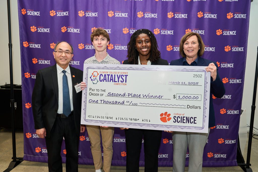 Four people holding a big check after the College of Science's Catalyst Competition