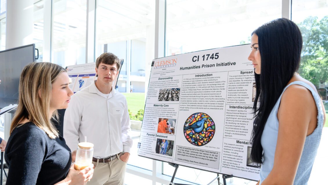 Brett Porter and Maddalyn Knaack display their Creative Inquiry project poster in Watt Family Innovation Center on April 11, 2025