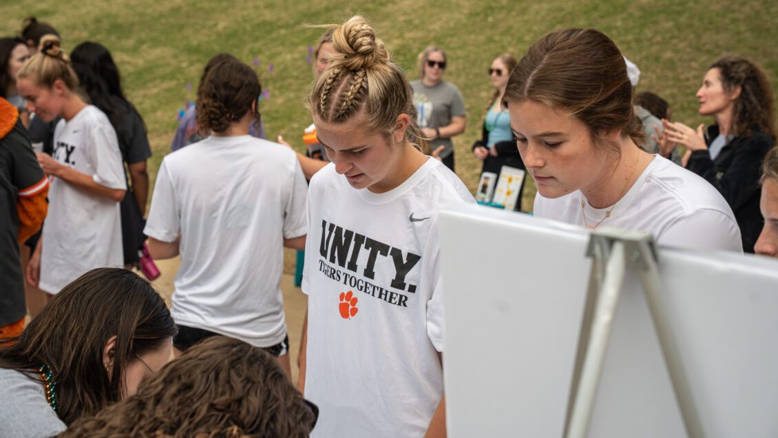 A women's soccer player wearing a 'Tigers Together' t-shirt registers for the 2025 Out of the Darkness Campus Walk