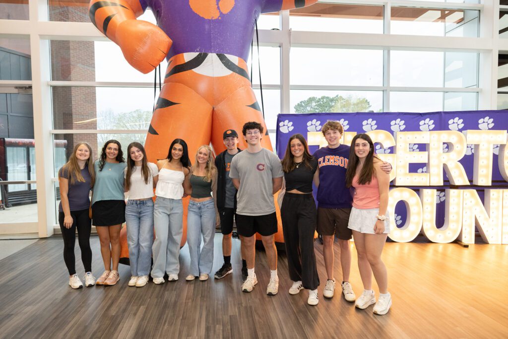 Students stand in front of an inflatable Tiger and a "TIGERTOWN BOUND" sign.