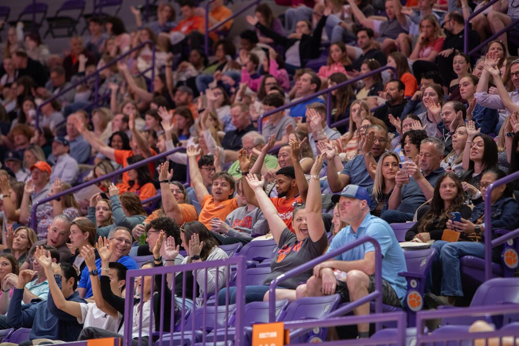 Parents and students wave their hands at Littlejohn Coliseum.