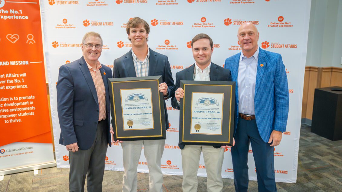 Charles Segars and Joseph Pope, middle, receive the Order of the Silver Crescent and are congratulated by Vice President for Student Affairs Doug Hallenbeck and President Jim Clements
