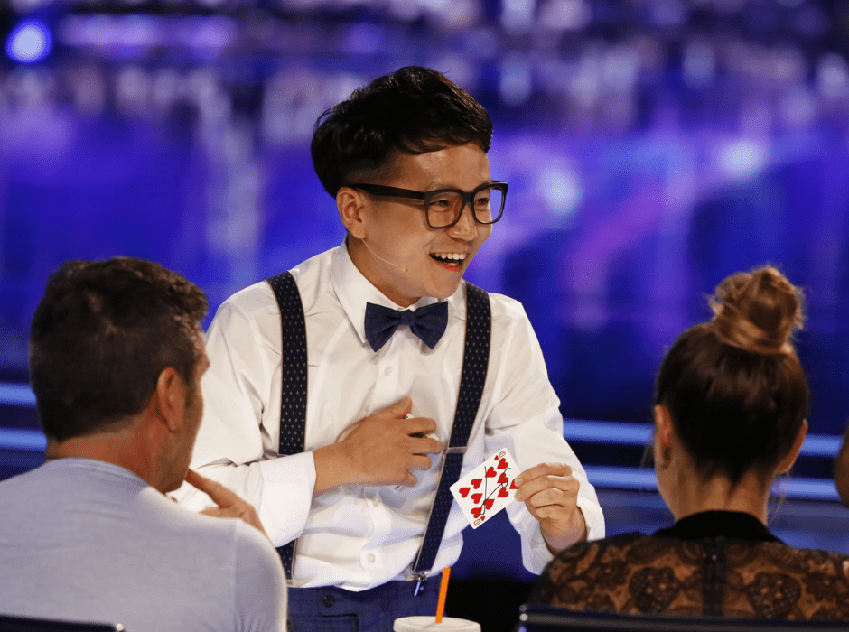 Magician Jeki Yoo performs a card trick on America's Got Talent