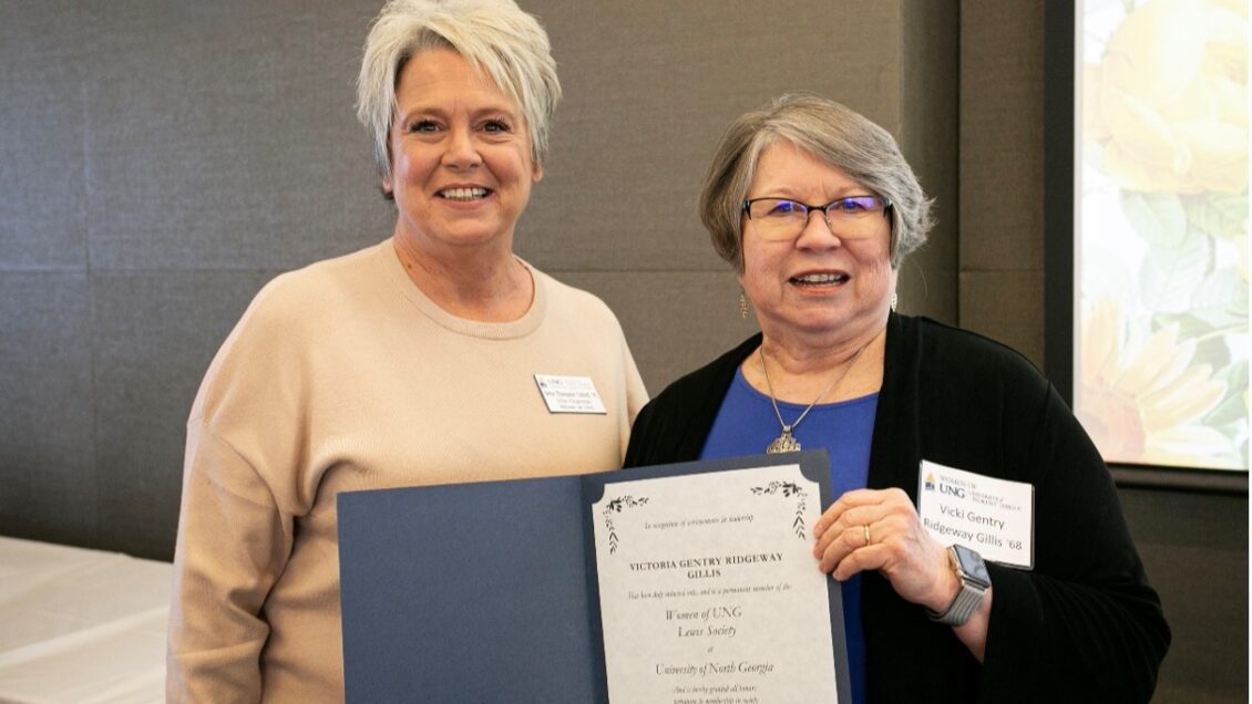 Betsy Thompson Oxford, Vice Chair, Women of North Georgia, presents Vicki Gillis with the Lewis Society award during her induction in 2025