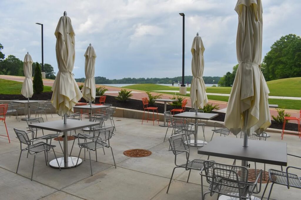 Outdoor tables and umbrellas overlooking the Walker Golf Course.