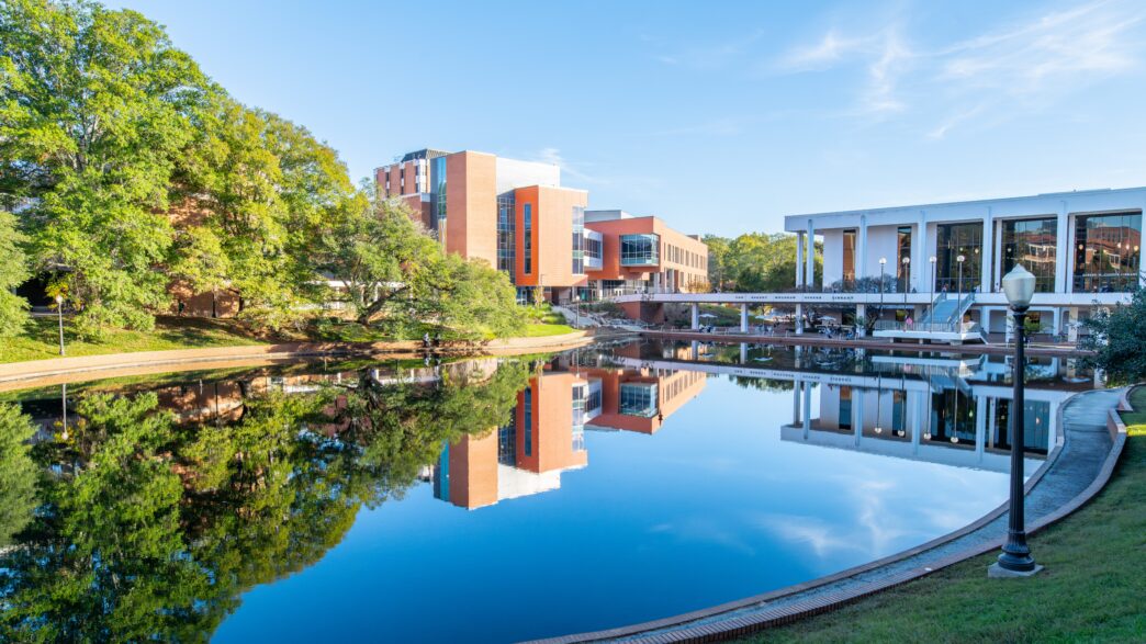 Daniel Hall, home of the College of Arts and Humanities, is reflected in the reflection pool on Clemson campus