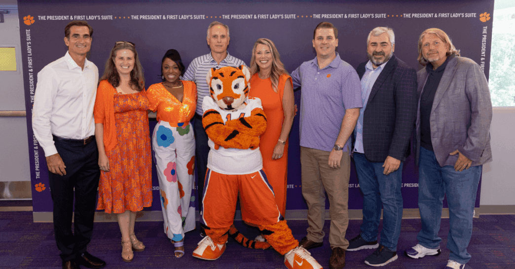 Executive Education Phd in Leadership cohort posing for a group picture in the President and First Lady Football Suite.