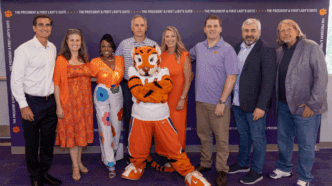 Executive Education Phd in Leadership cohort posing for a group picture in the President and First Lady Football Suite.
