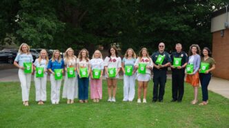 Clemson Panhellenic Council, Chief Campos, Interim Chief Harrington, Jennifer Goree and Kelley Metcalfe post for a photo while holding Green Screen testing kigs