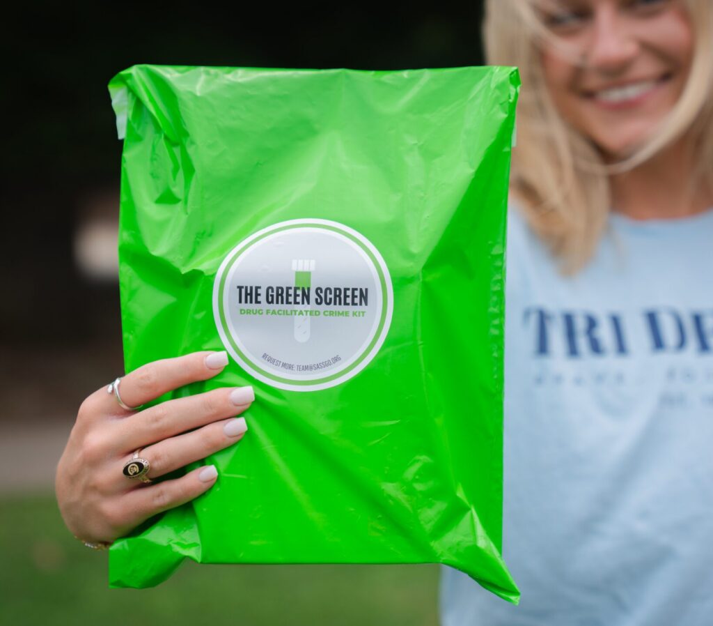 A sorority member holds up a light green Green Screen bag
