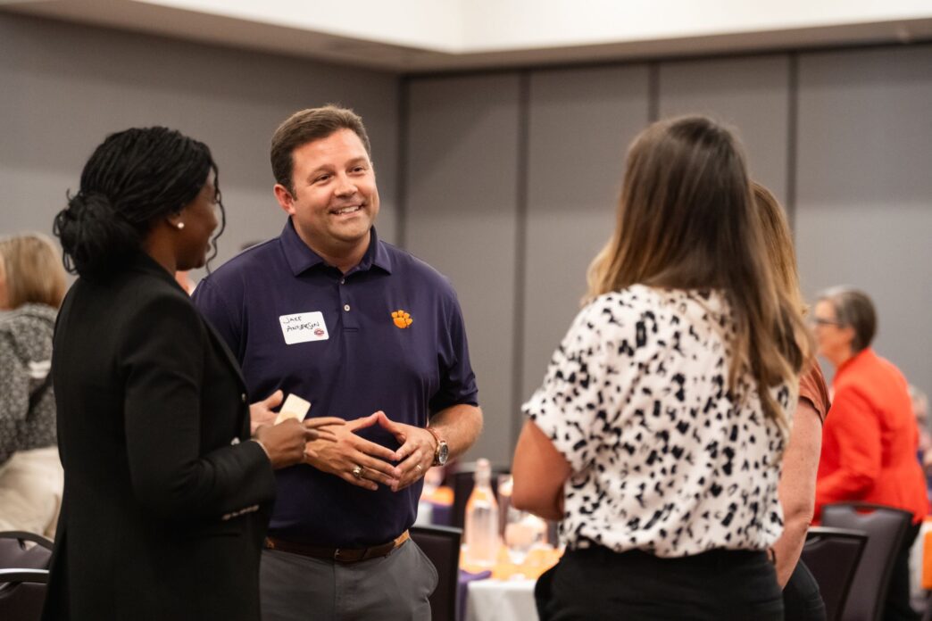 Staff chat at the Presidents Leadership Institute reunion.