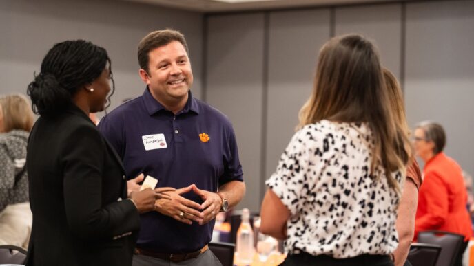 Staff chat at the Presidents Leadership Institute reunion.