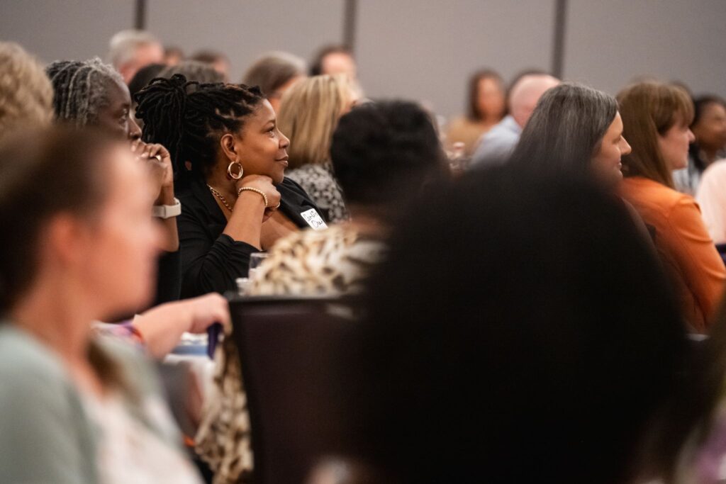 Staff listen at Madren Conference Center.