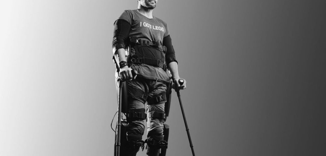 Adam Gortlisky standing with arm, leg and torso braces wearing a T-shirt that reads I GOT LEGS.