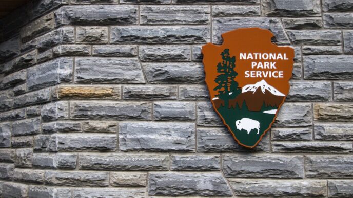 Insignia for the United States National Park Service on a visitors center on a rock wall.