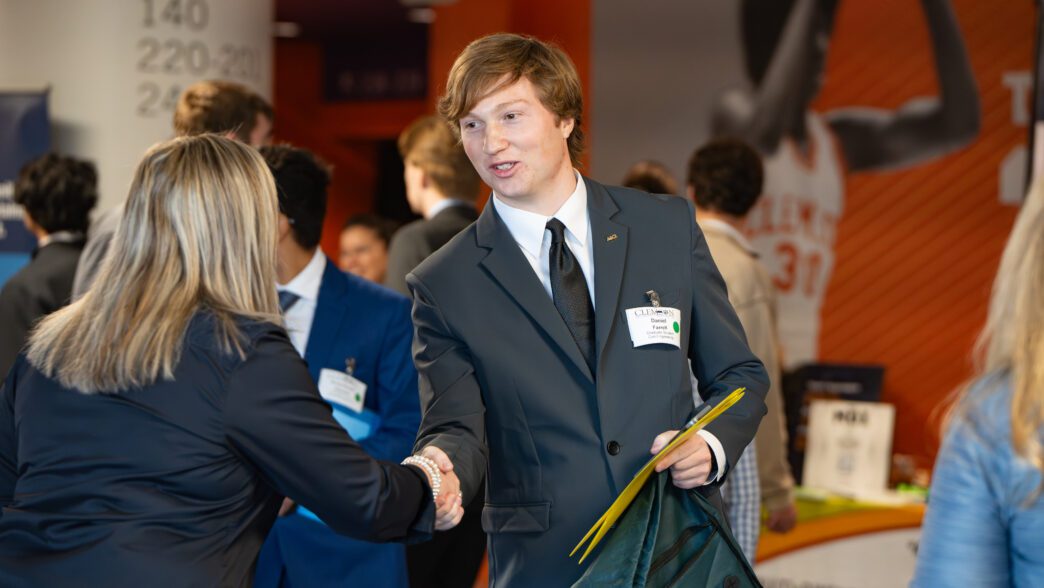 A student greets a prospective employer at the 2025 Spring Career Fair
