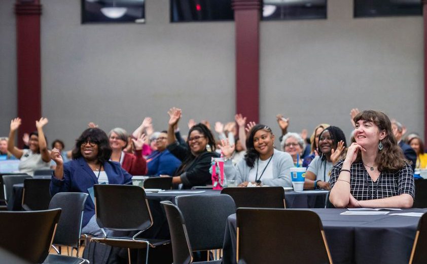 Audience members raising their hands