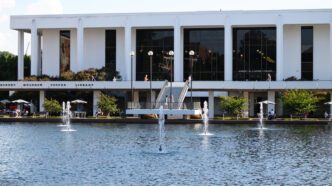 A picture of Cooper Library with the reflection pond in the foreground