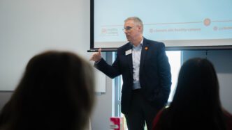 Doug Hallenbeck, vice president for Student Affairs, speaks to a group of students in August 2025