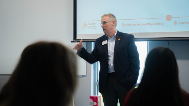 Doug Hallenbeck, vice president for Student Affairs, speaks to a group of students in August 2025