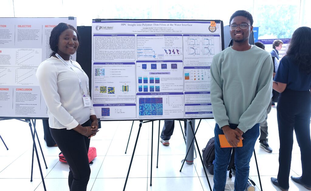 Two students stand in front of their research poster for HPC Day 
