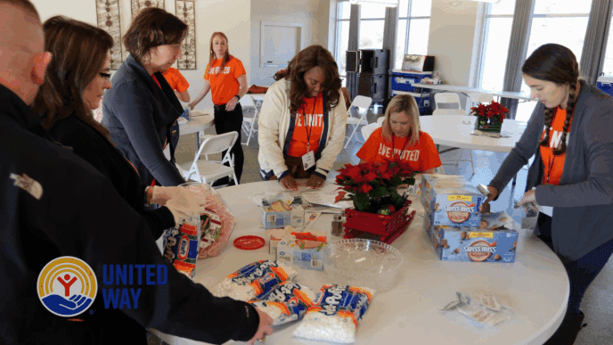 Clemson faculty and staff wearing orange LIVE UNITED shirts collect dry goods.