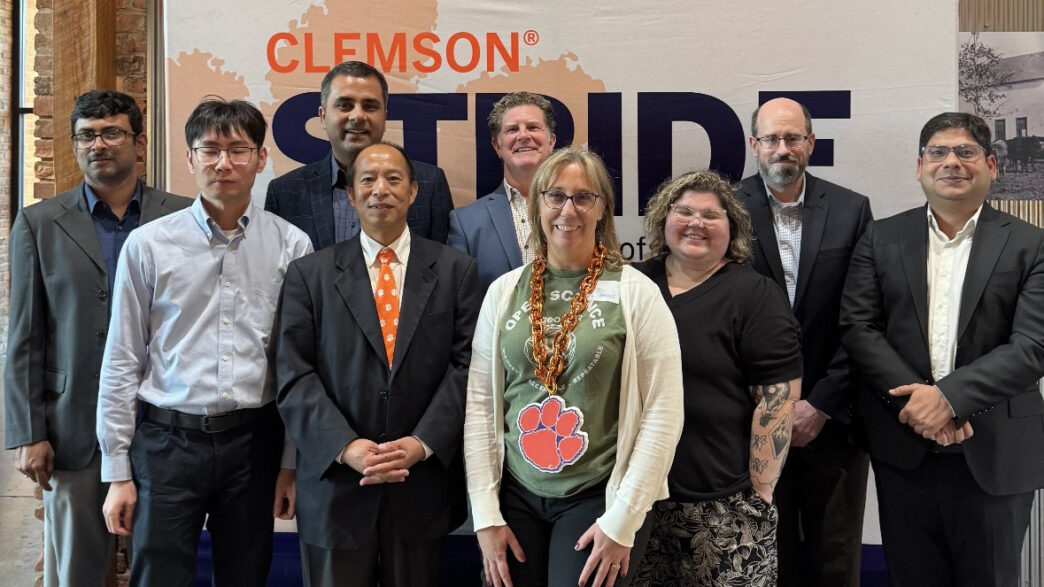 Members of the ART Academy post in front of a Clemson STRIDE sign.
