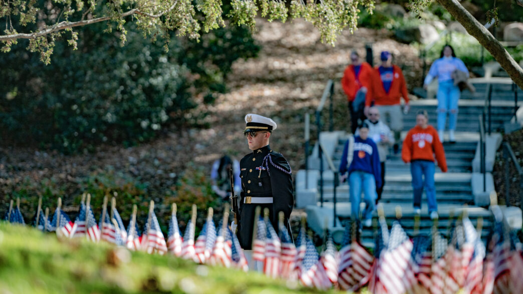 A student in Pershing Rifles looks out over the Scroll of Honor Memorial at Clemson University