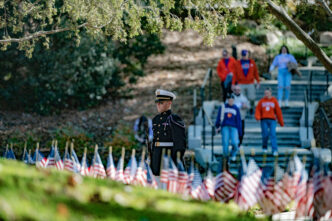A student in Pershing Rifles looks out over the Scroll of Honor Memorial at Clemson University