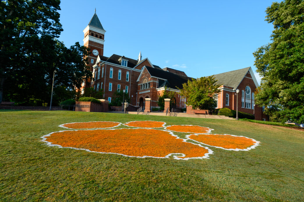 Tiger paw painted on Bowman Field with Tillman Hall in the background