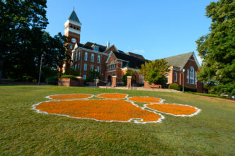 Tiger paw painted on Bowman Field with Tillman Hall in the background