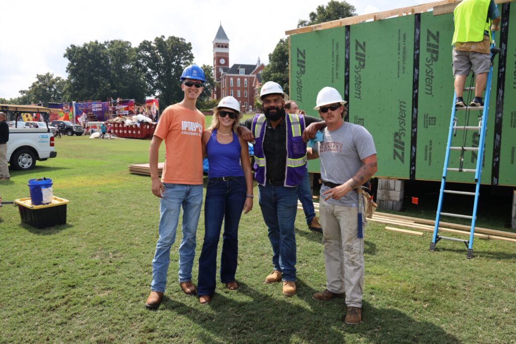 A group of people smiling outdoors