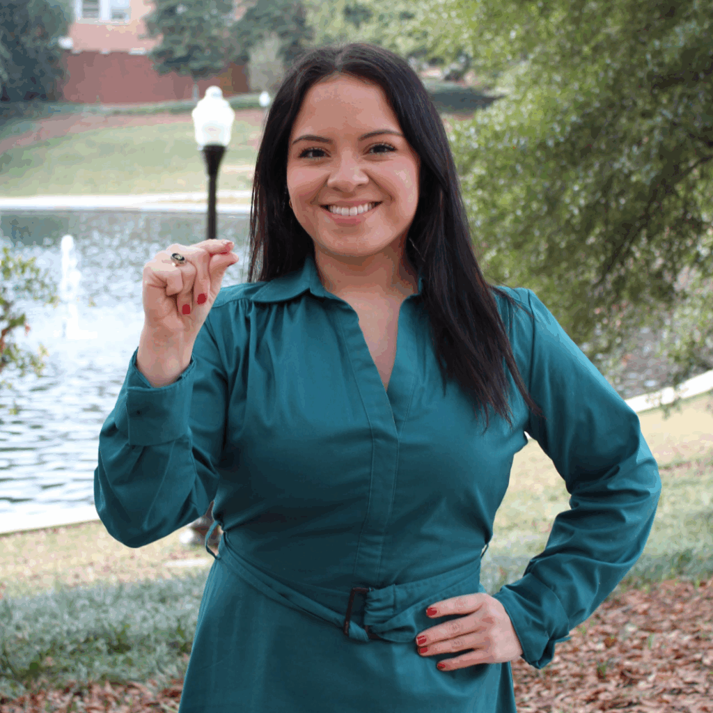 Jennifer Garcia doing the sign for "20" in American Sign Language.