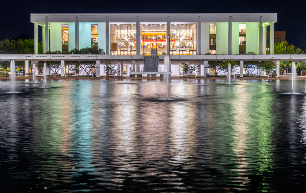 The fountains in the newly-refurbished reflection pool in front of the R.M. Cooper Library operate into the night causing light to reflect and dance over the ripples on the water.