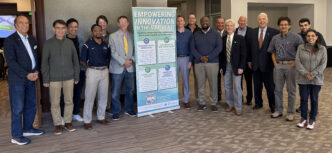 16 people posing for a group photo