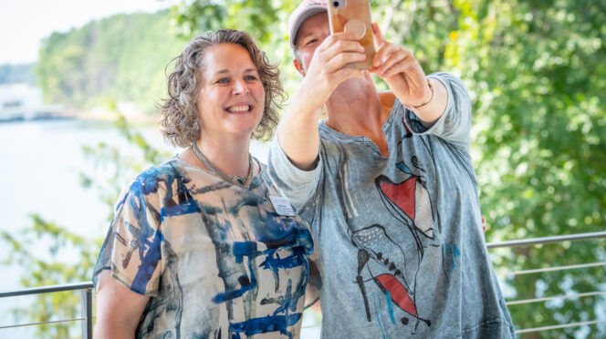 Chief Well-Being Officer Anna Courie smiles for a selfie alongside a Clemson staff member at Andy Quattlebaum Outdoor Education Center