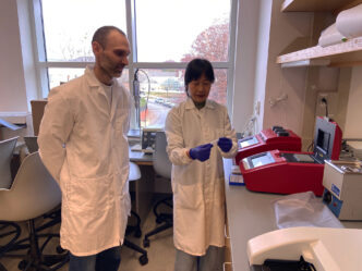 Clemson University scientists Alexis “Stocko” Stamatikos and Jing “Jennifer” Echesabal-Chen prepare to use a thermocycler, a machine that amplifies DNA, to confirm the genetic makeup of immune cells called macrophages.