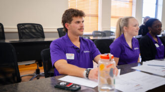 A male student in a purple shirt inside a classroom at Clemson University