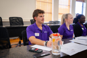 A male student in a purple shirt inside a classroom at Clemson University