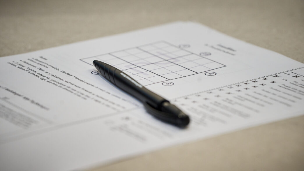A back pen sits on top of a piece of paper with a sudoku puzzle