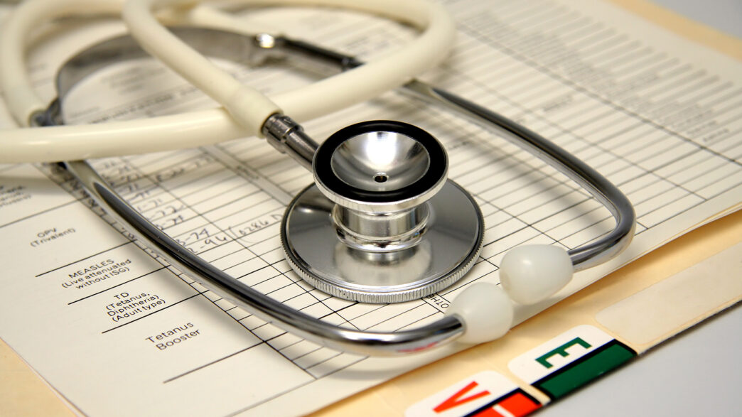 White stethoscope on a medical chart.