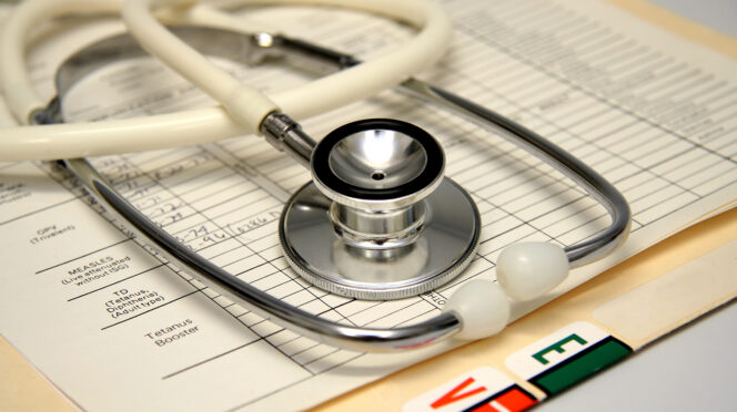 White stethoscope on a medical chart.