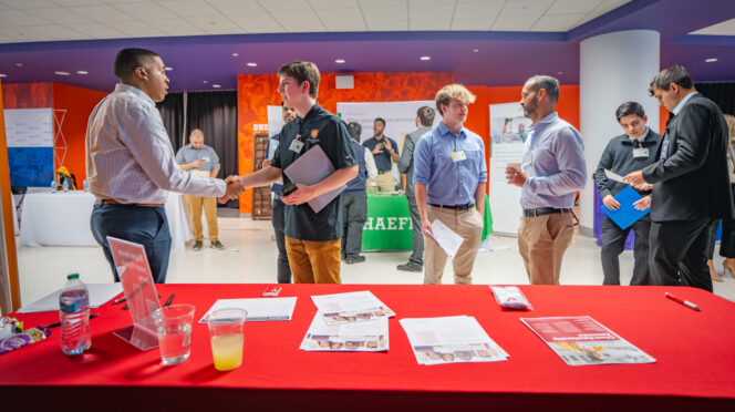 Students interact with prospective employers at a Career Fair in Littlejohn Coliseum
