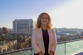 Jane Layton standing with Greenville skyline behind her.