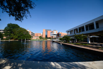 The Cooper Library and Daniel Hall are seen in the distance with the Reflection Pond in the foreground.