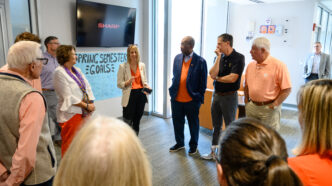 Individuals gather inside a hallway in a building on Clemson's campus