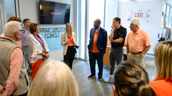 Individuals gather inside a hallway in a building on Clemson's campus